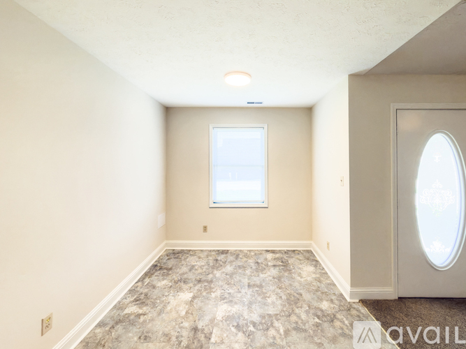 A room with a marble floor and a window.