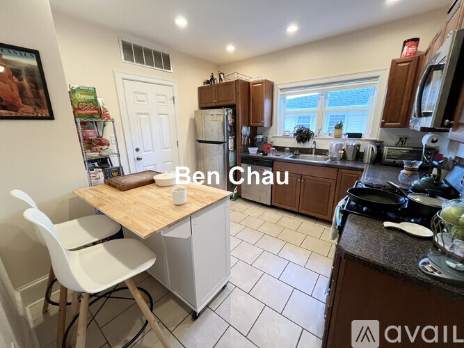A kitchen with a table and chairs and a fridge.
