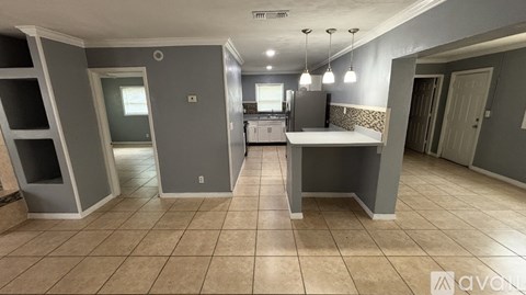 A kitchen area with a refrigerator, oven, and sink.