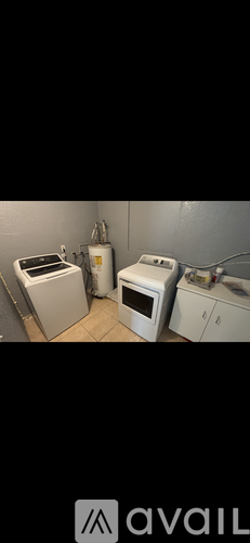 A white microwave oven is placed on a counter.