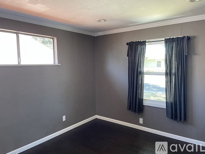 A room with a window and a view of the outside.