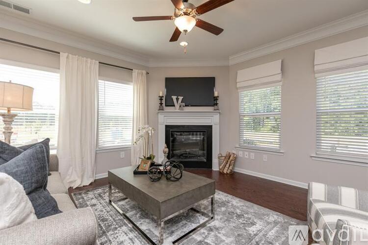 A living room with a fireplace and a television above it.
