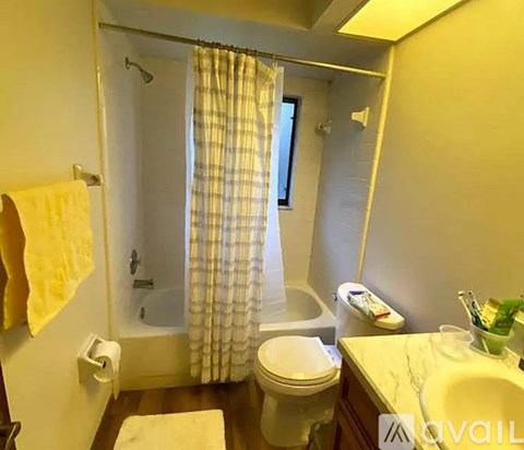 A bathroom with a toilet, sink, and shower.