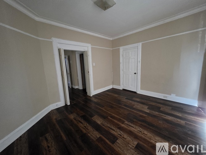 A room with wooden floors and white walls.