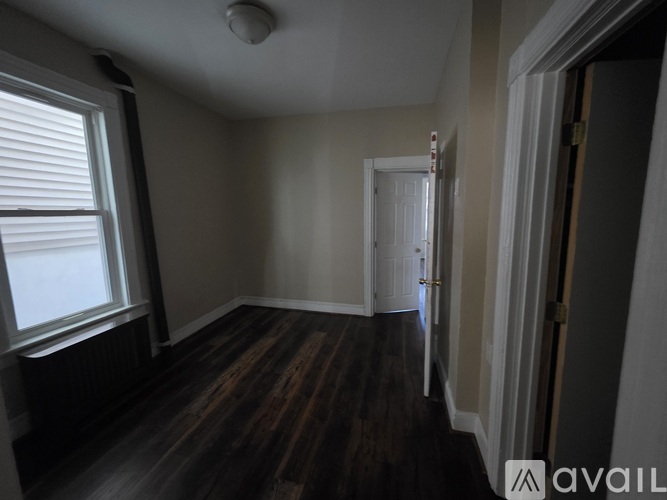 A room with wooden floors and a white door.