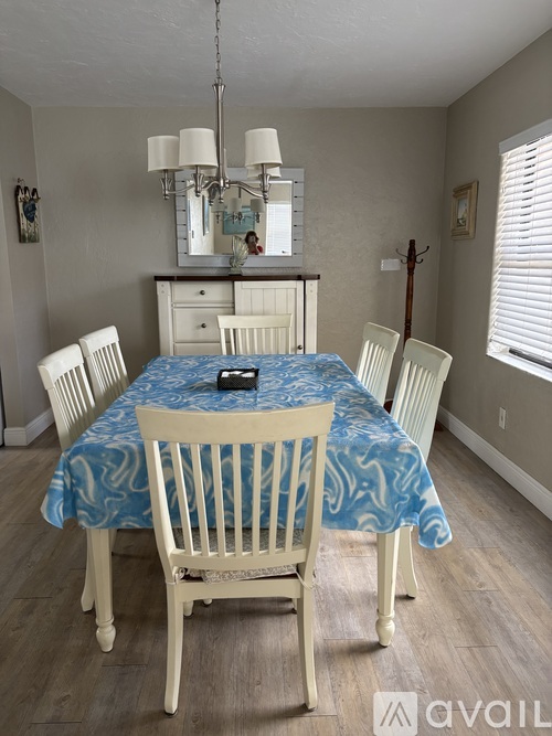 A dining room with a table set for four.