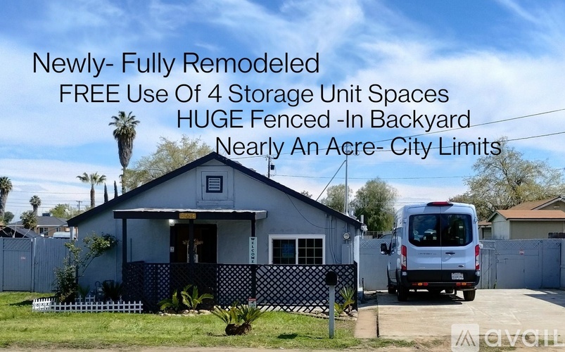 A house with a van parked in front and text overlay describing it as newly-fully remodeled with free use of 4 storage unit spaces.