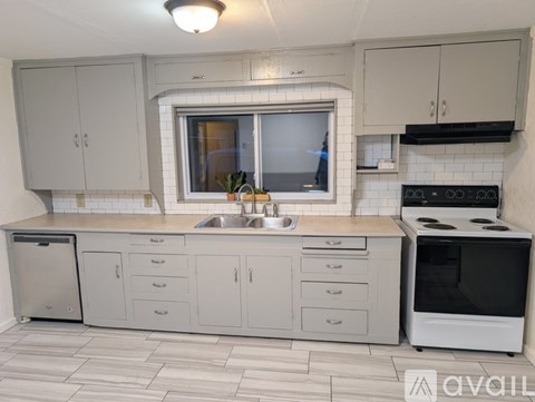 A kitchen with white cabinets and a black stove top oven.