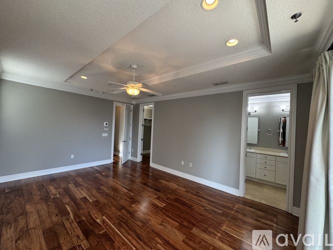 A room with wooden floors and a ceiling fan.