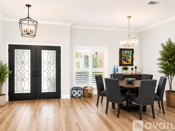 A dining room with a table set for six.