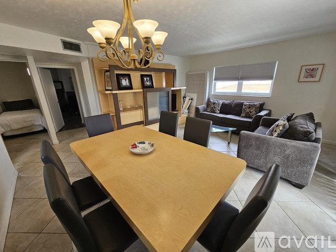 A dining room with a wooden table and chairs.