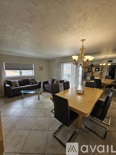 A dining room with a wooden table and chairs.