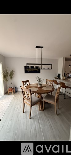 A dining room with a wooden table and chairs.