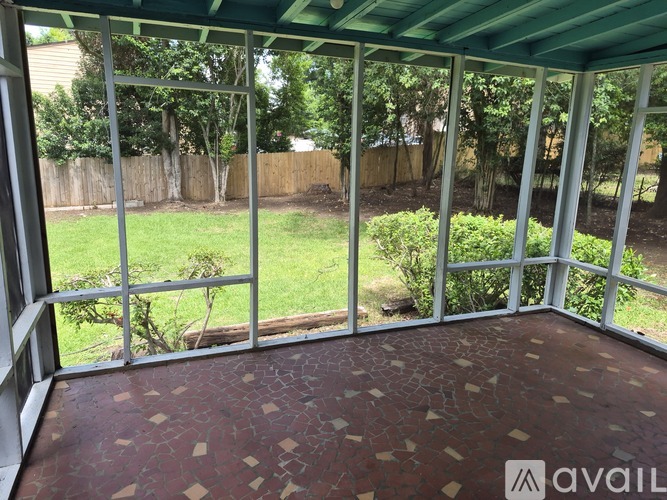 A patio with a green roof and a brick floor.