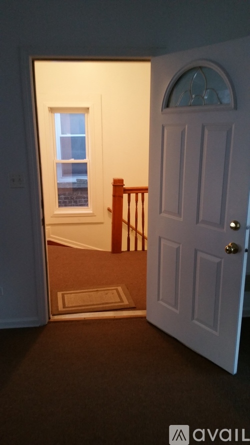 A white door is open to a hallway.