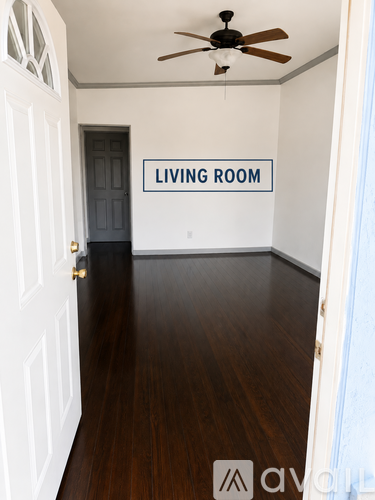 A living room with a sign on the wall.