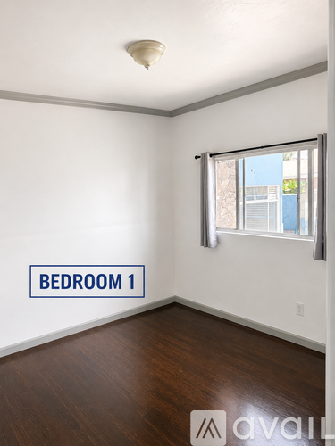 Bedroom 1 has a window and wooden floors.