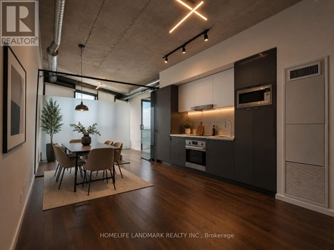 A modern kitchen with a dining table and chairs.