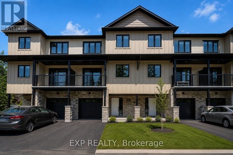 A large, modern two-story house with a balcony on the second floor.
