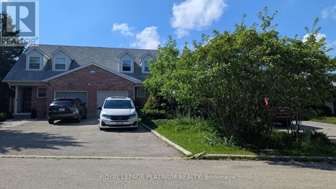 A house with a car parked in front of it.
