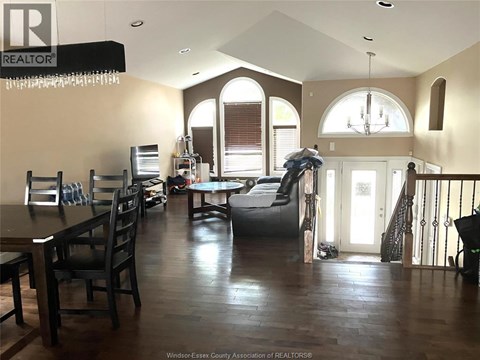 A large open living room with a dining table and chairs.