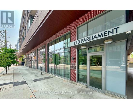 A building with a glass facade and a sign that reads "120 PARLIAMENT".