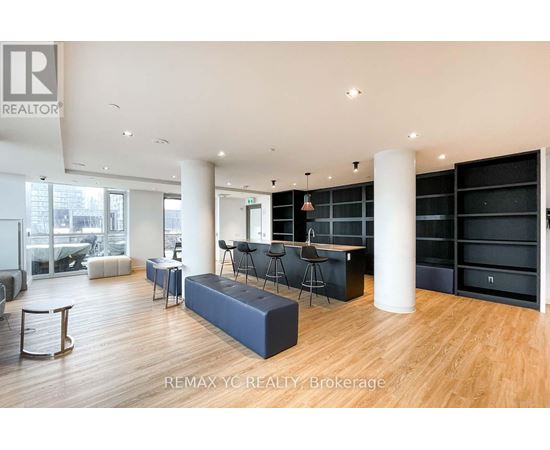 A spacious living room with a large sofa and a bar area.