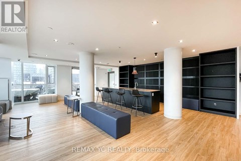 A spacious living room with a large sofa and a bar area.