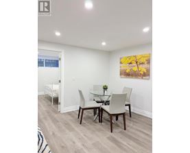 A dining room with a glass table and chairs.