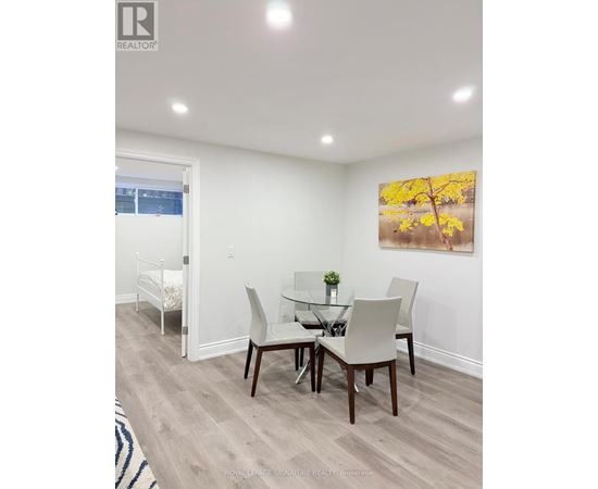 A dining room with a glass table and chairs.