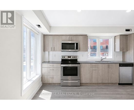 A modern kitchen with a stove top oven and microwave above the counter.