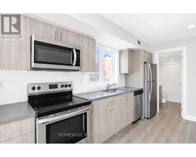 A kitchen with a stove, microwave, and refrigerator.