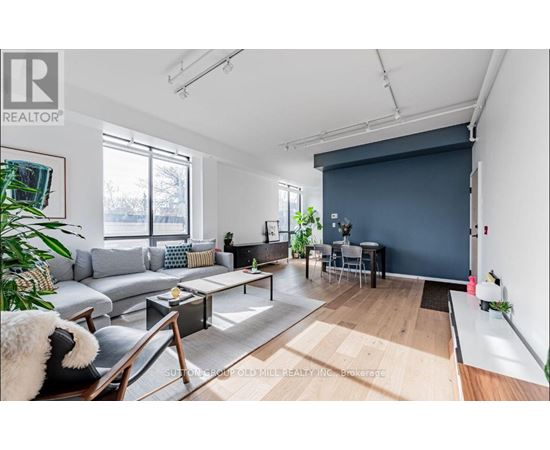 A living room with a grey sofa and a coffee table.