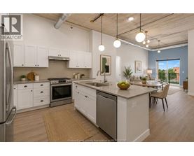 A modern kitchen with white cabinets and stainless steel appliances.