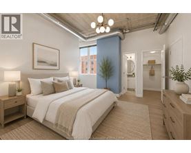 A bedroom with a large bed, a nightstand, and a plant.