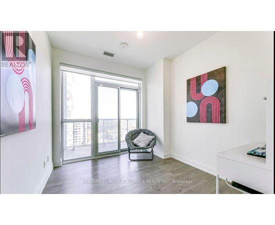 A realtor painting is on the wall in a spacious living room.