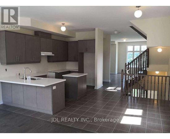 A kitchen with dark brown cabinets and a white countertop.