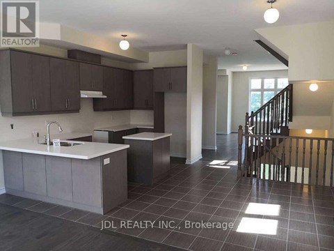 A kitchen with dark brown cabinets and a white countertop.