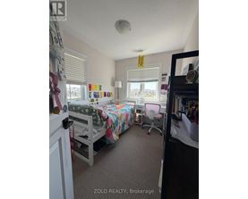 A bedroom with a bunk bed and a desk.