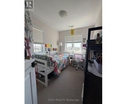 A bedroom with a bunk bed and a desk.