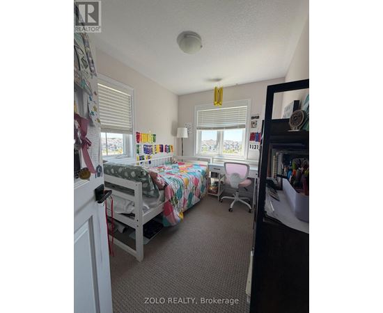 A bedroom with a bunk bed and a desk.