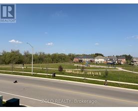 A street view of a residential area with houses and trees.