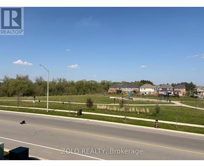 A street view of a residential area with houses and trees.