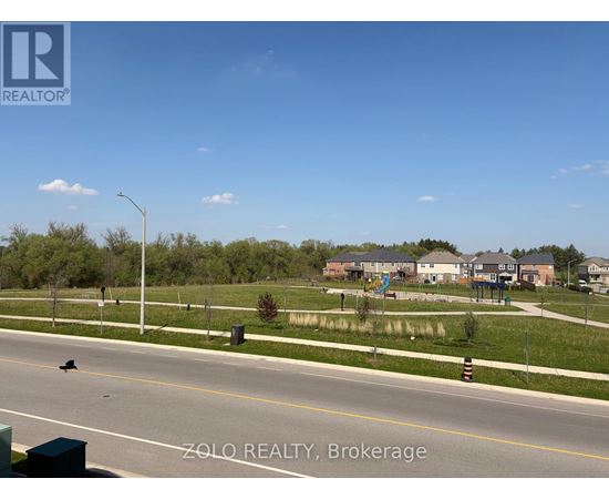 A street view of a residential area with houses and trees.