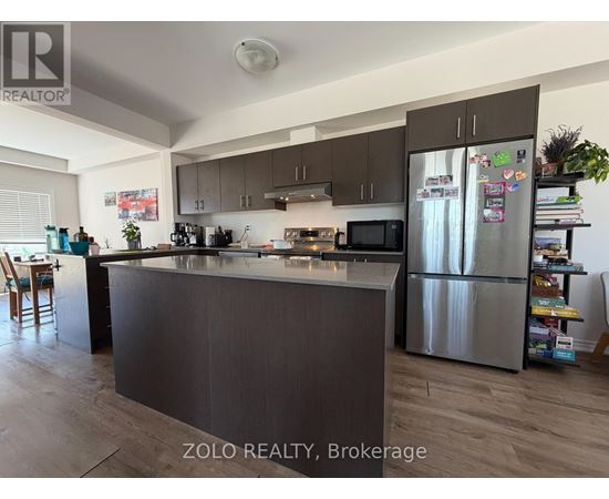 A kitchen with a refrigerator covered in magnets.