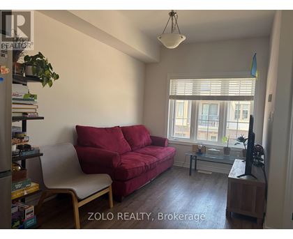A living room with a red couch and a television.