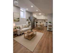 A well-lit, modern kitchen and living room with wooden floors and furniture.