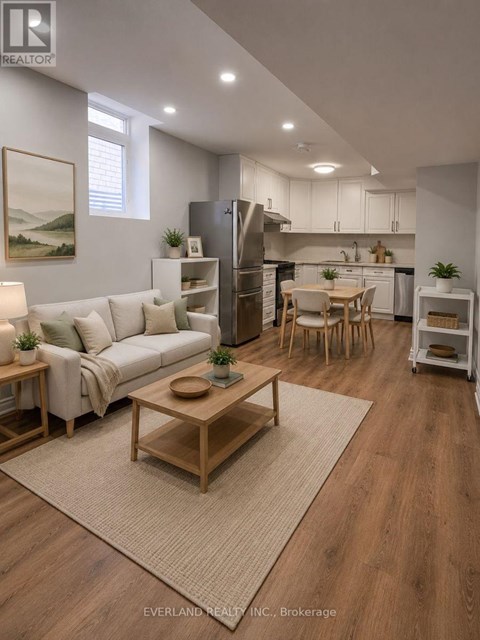 A well-lit, modern kitchen and living room with wooden floors and furniture.