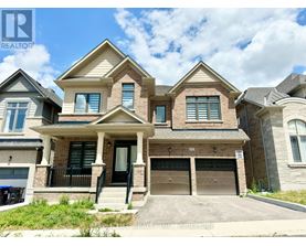 A large, two-story house with a garage is for sale.
