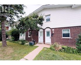 A house with a white door and a brick wall.